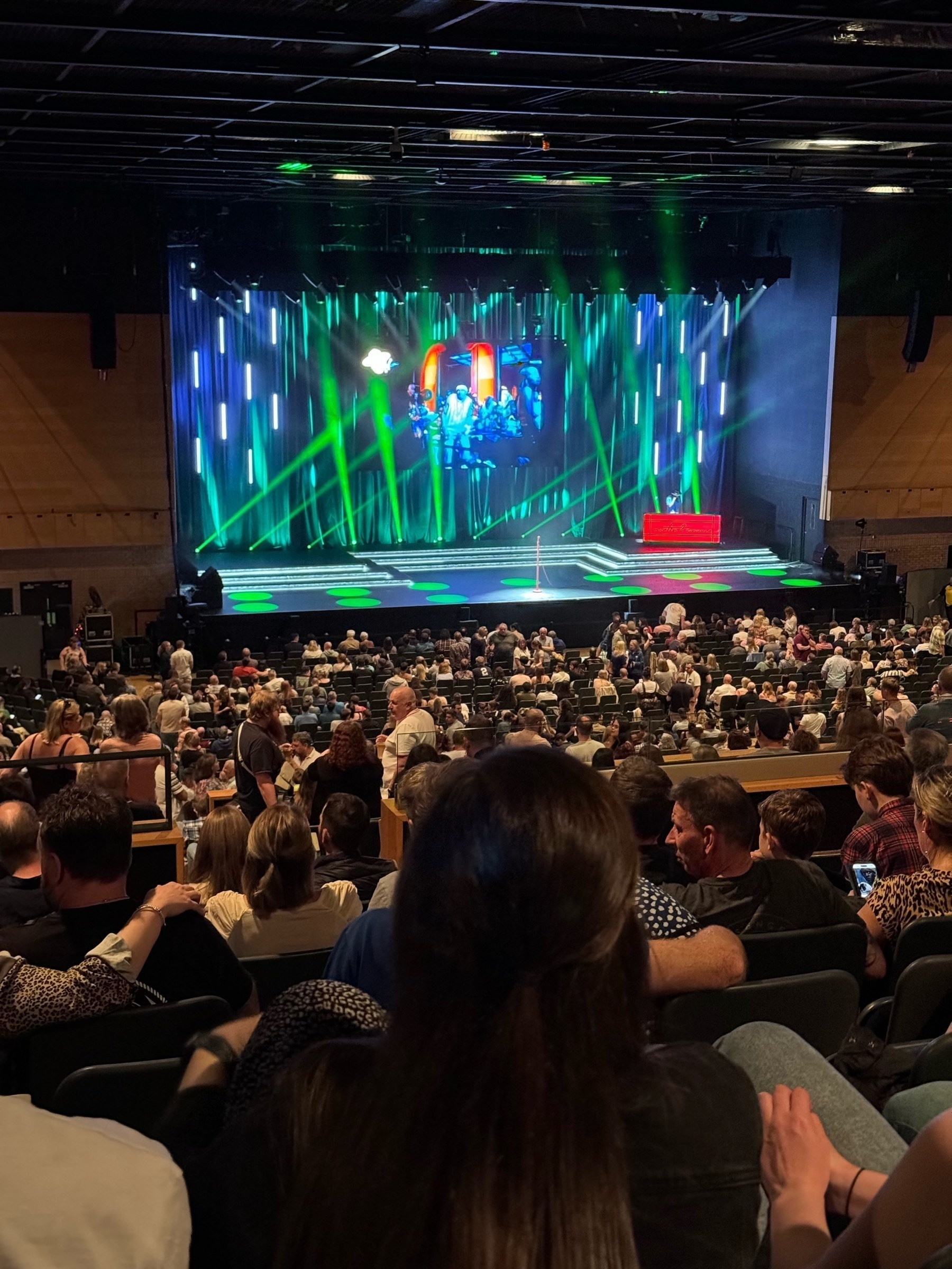 Picture of the stage from my seat at Romesh stand up gig during interval. View shows most of Crowd waiting for next part as seated high up