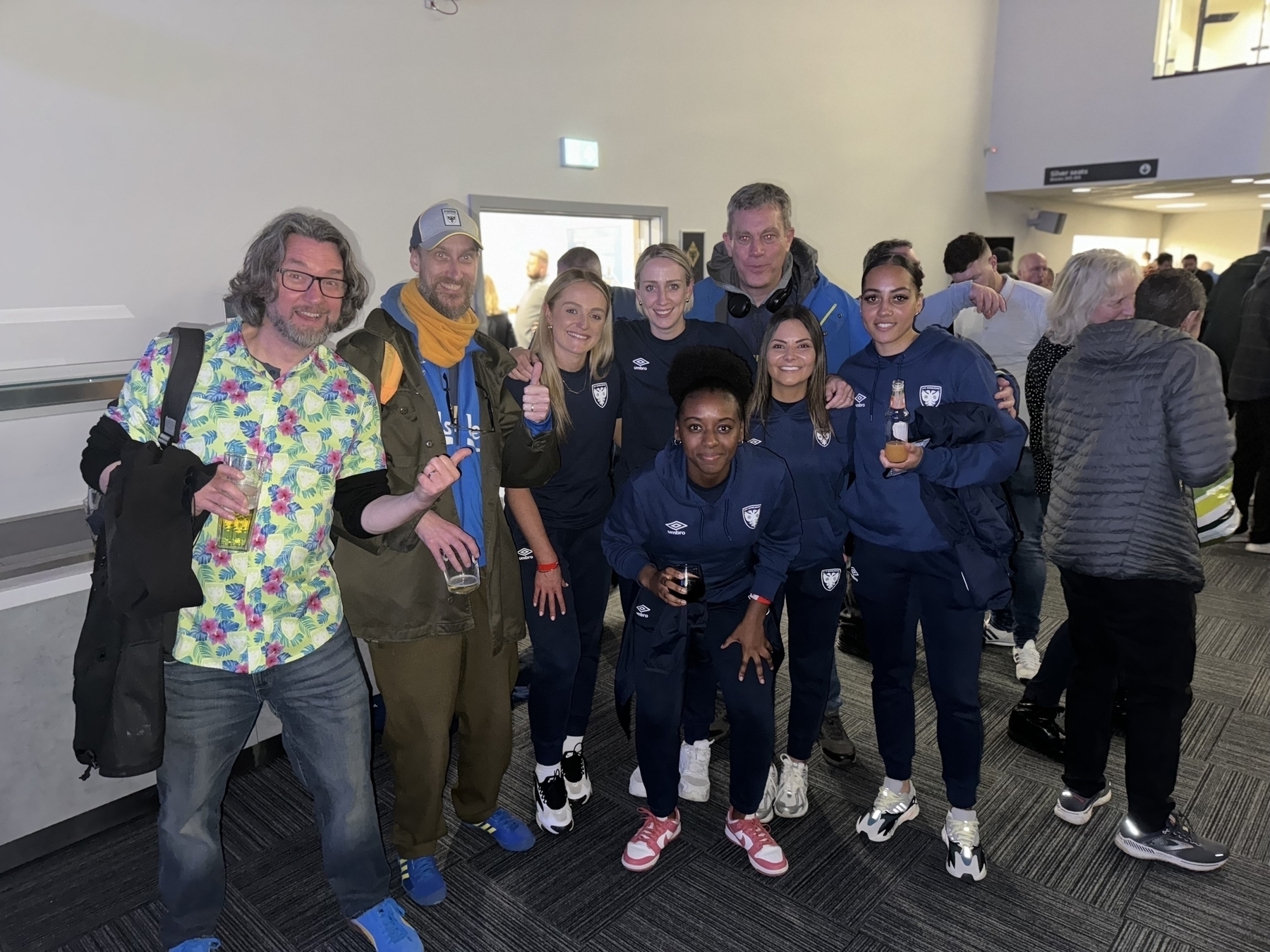 Matthew, Adam and Mark in group photo with a number of the AFC Wimbledon women’s team, champions of the 2023/24 season