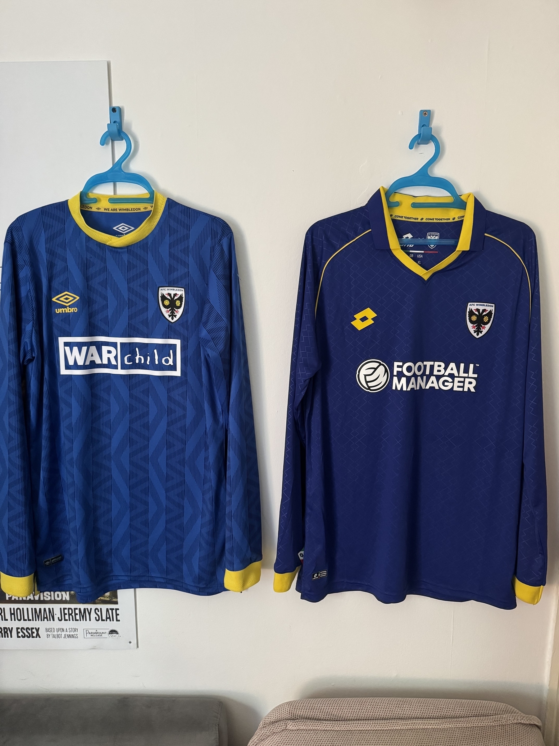 Photos of my football shirts hanging in my office. Left shirt last season right shirt new season. Loving the new design