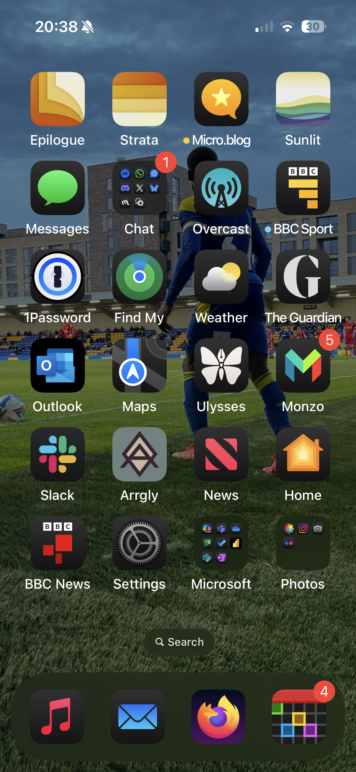 A smartphone home screen displays various app icons, including Messages, Weather, Maps, and Photos, set against a blurred background of a soccer match.