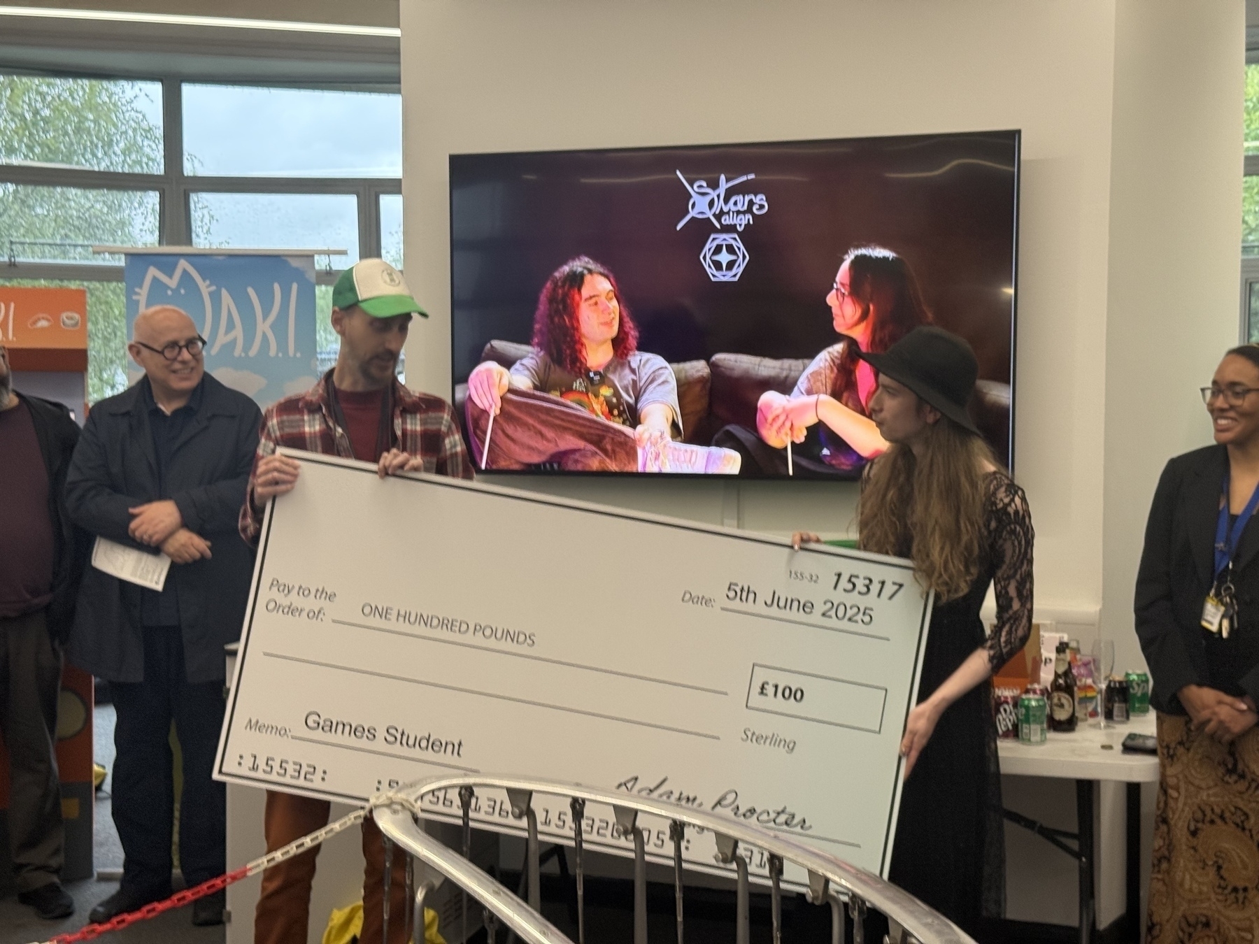 Me handing over a giant cheque as part of the prize giving for students at the degree show for Games Design& Art