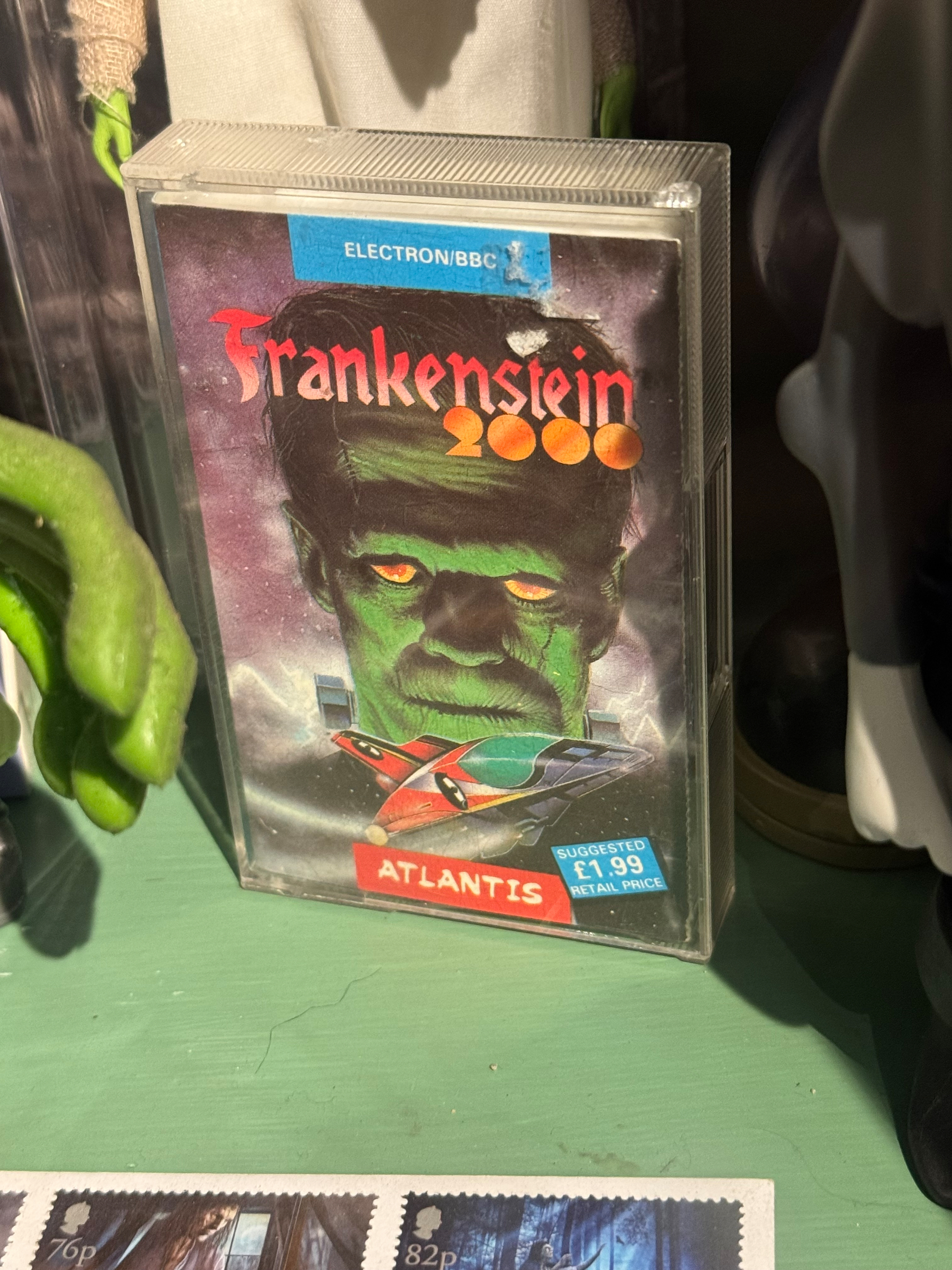 A video game cassette titled Frankenstein 2000 is displayed with a suggested price of £1.99 and features a futuristic design and bold red text.